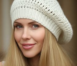 Вязаный берет молочного цвета.